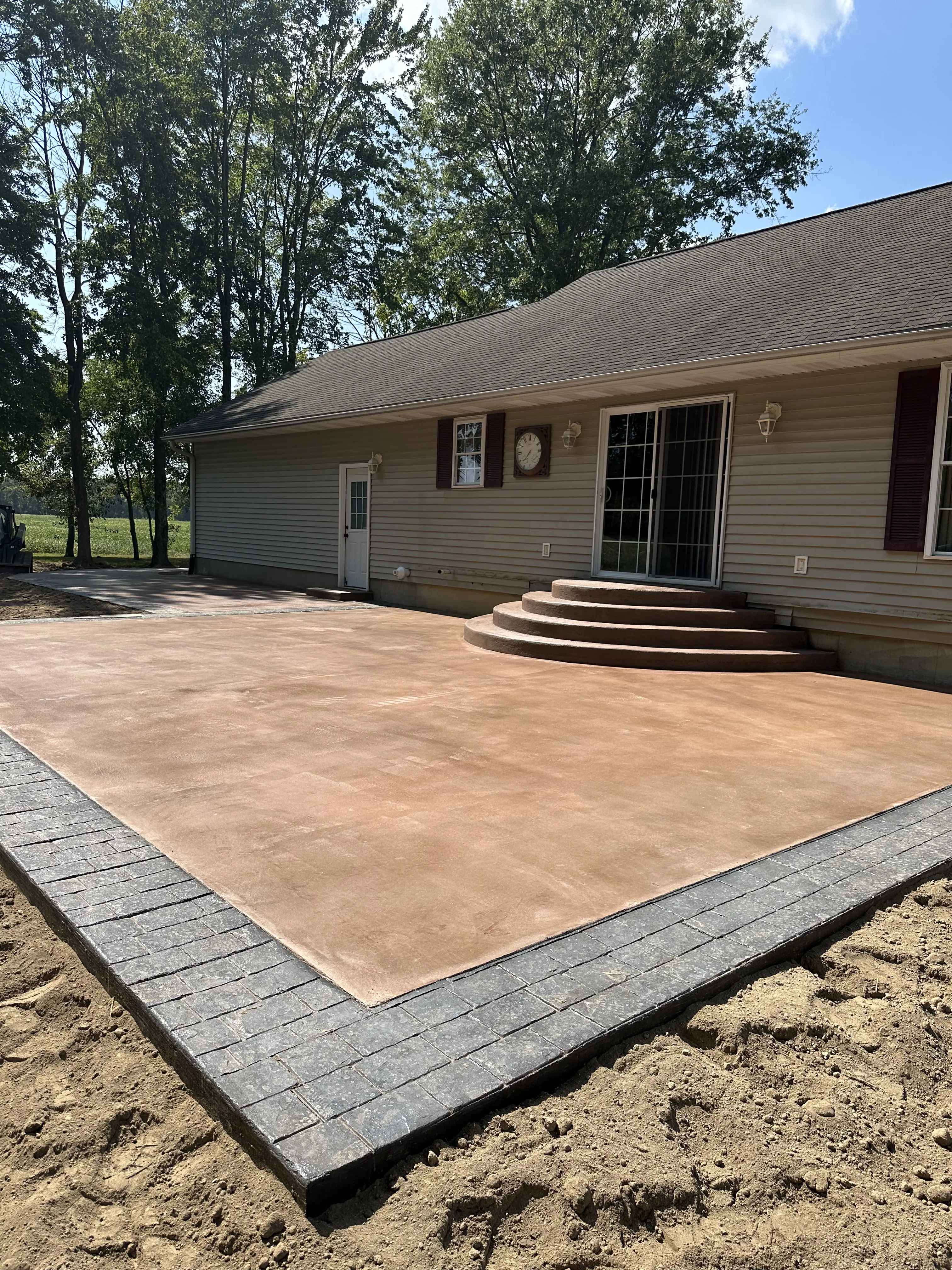 Colored patio with stamped brick border